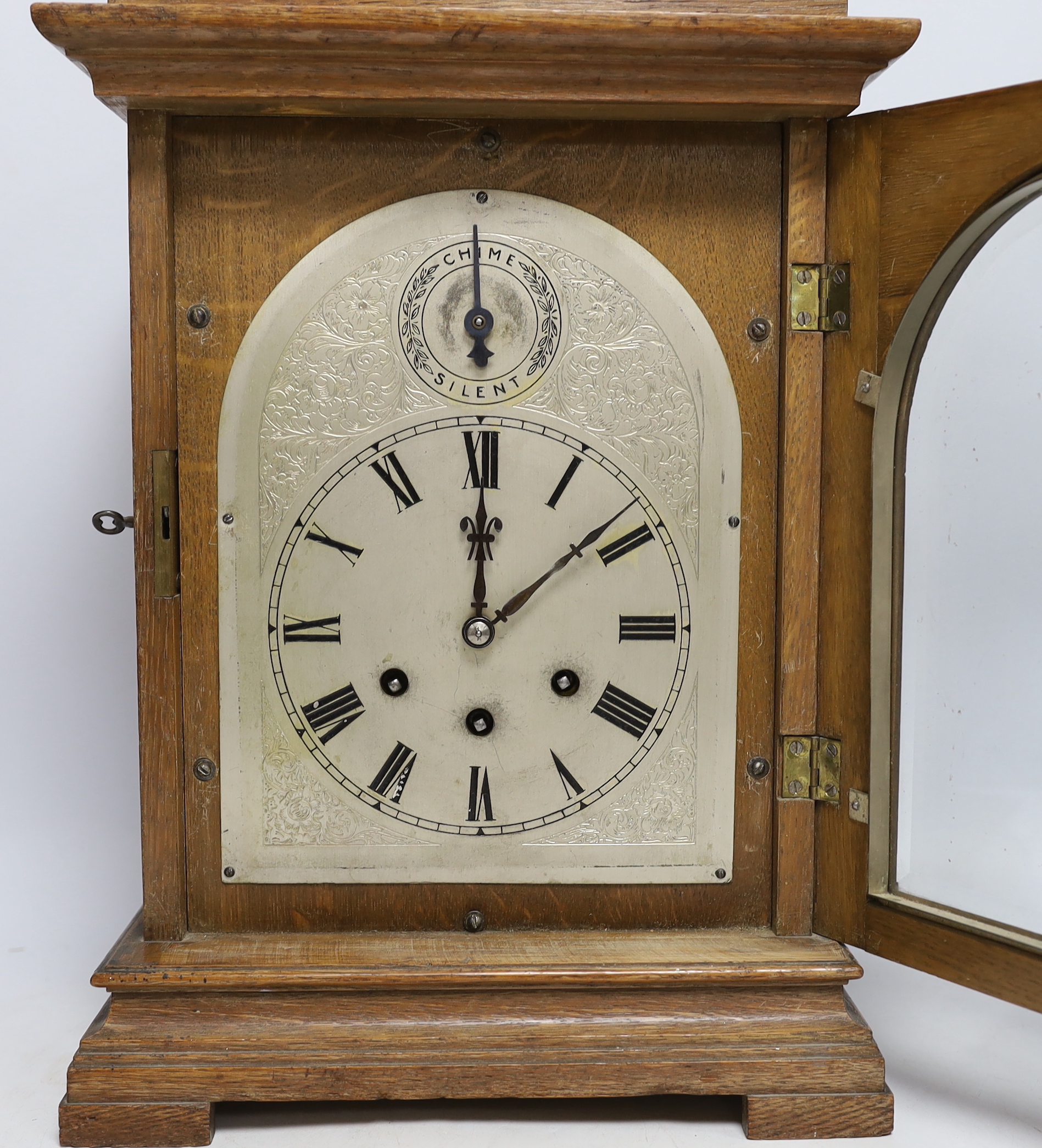 A 1920's Gustav Becker oak bracket clock with three train movement, striking and chiming on five gongs, 42.5cm high